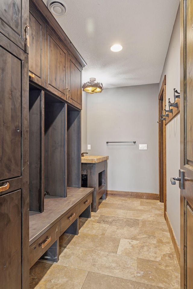 3920 Hawthorne Cir, Chanhassen, MN 55331 - mudroom with baseboards, light stone finish flooring, and recessed lighting