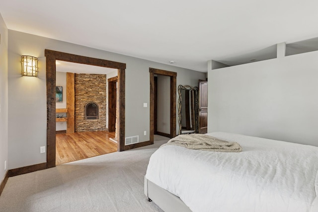 3920 Hawthorne Cir, Chanhassen, MN 55331 - carpeted bedroom featuring a stone fireplace and baseboards