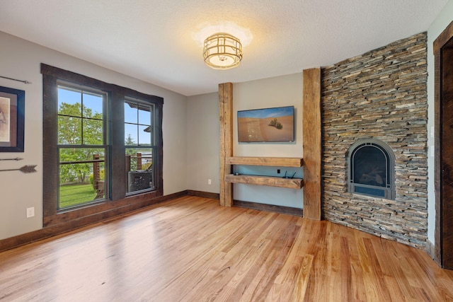 3920 Hawthorne Cir, Chanhassen, MN 55331 - unfurnished living room with wood finished floors, baseboards, and a fireplace