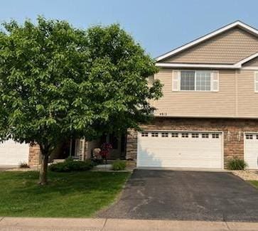 4812 200th St N, Forest Lake, MN 55025 - view of front facade with driveway, an attached garage, and a front lawn