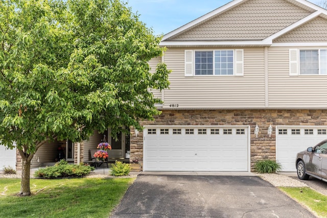 4812 200th St N, Forest Lake, MN 55025 - view of front of home with stone siding, driveway, and a garage