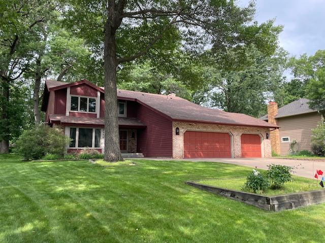5929 Oxford St N, Shoreview, MN 55126 - view of front facade with a garage, driveway, and a front yard