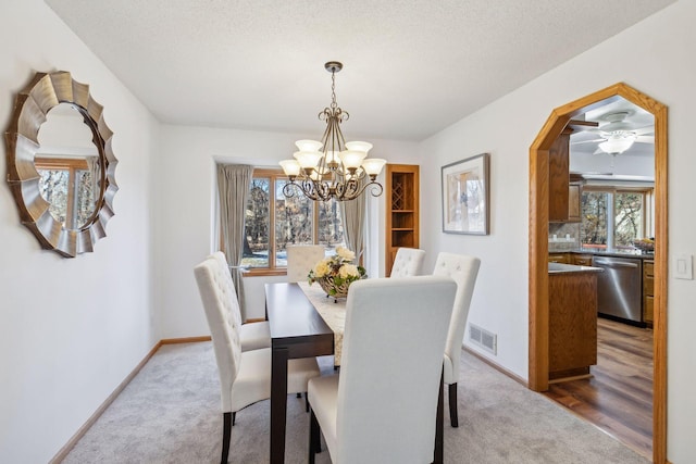 5929 Oxford St N, Shoreview, MN 55126 - dining space with carpet flooring, a chandelier, a ceiling fan, arched walkways, and a textured ceiling