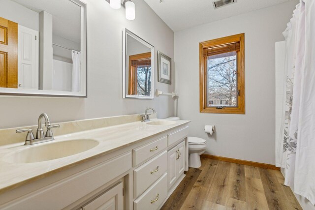 5929 Oxford St N, Shoreview, MN 55126 - bathroom with double vanity, wood finished floors, and a shower with shower curtain