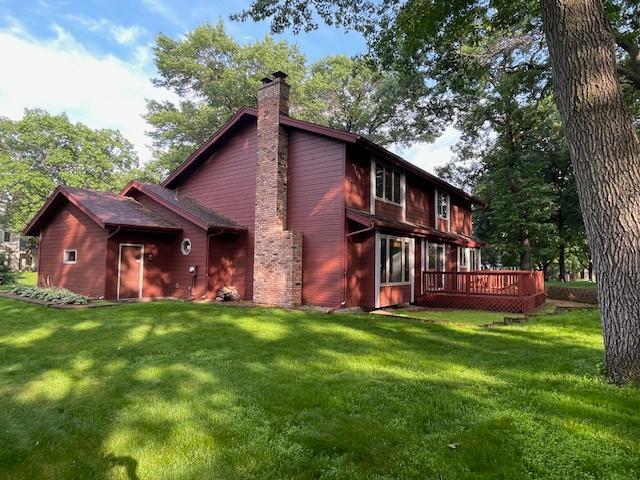5929 Oxford St N, Shoreview, MN 55126 - rear view of house featuring a chimney, a deck, and a lawn