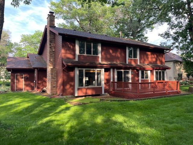5929 Oxford St N, Shoreview, MN 55126 - rear view of property with a chimney, a deck, and a lawn