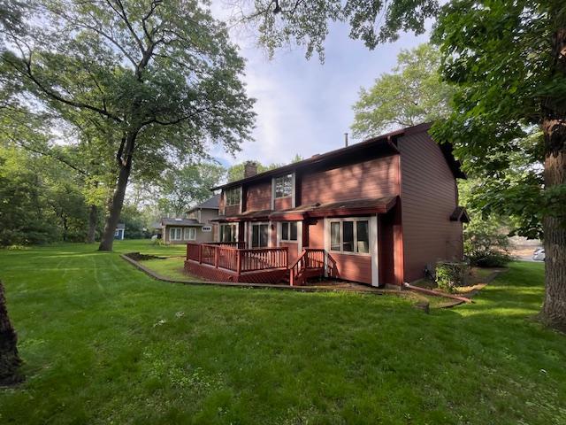 5929 Oxford St N, Shoreview, MN 55126 - rear view of house with a wooden deck, a yard, and a chimney