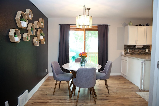 6014 6th St, Lake Park, MN 56554 - dining area featuring light wood-style floors, a chandelier, and baseboards