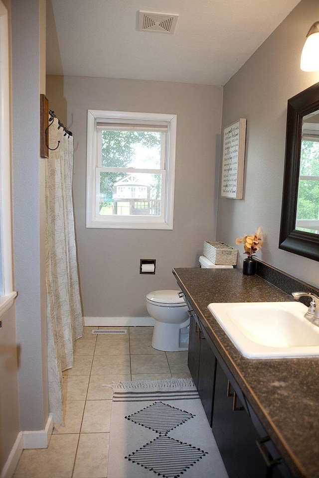 6014 6th St, Lake Park, MN 56554 - bathroom with vanity, toilet, tile patterned flooring, and baseboards