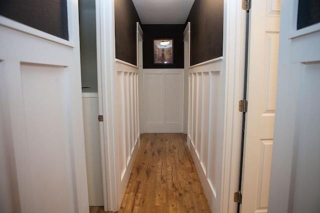 6014 6th St, Lake Park, MN 56554 - hallway featuring a decorative wall, wood finished floors, and wainscoting