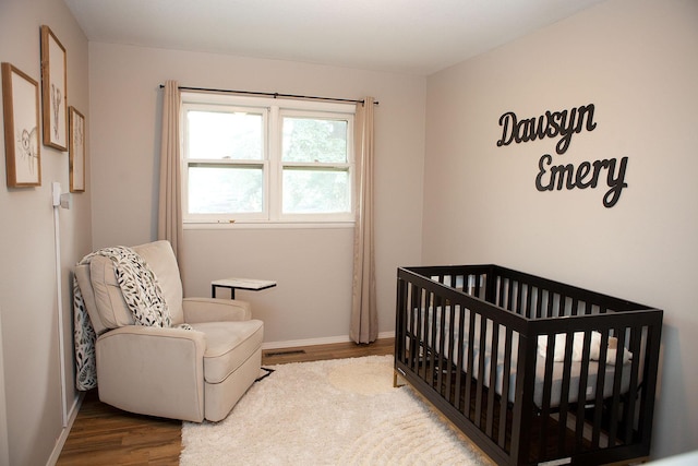 6014 6th St, Lake Park, MN 56554 - bedroom with wood finished floors, baseboards, and a nursery area