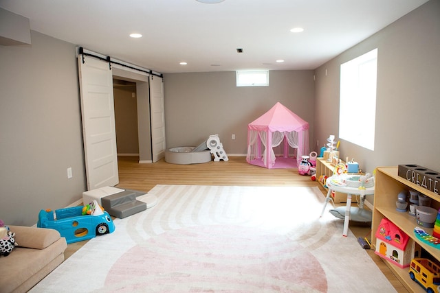6014 6th St, Lake Park, MN 56554 - playroom with a barn door, wood finished floors, and recessed lighting