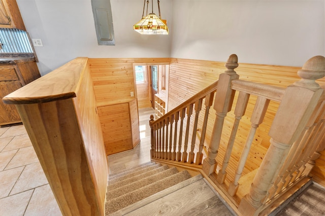51470 Rush Lake Trl, Nessel Twp, MN 55069 - stairway featuring electric panel, wood walls, and tile patterned floors