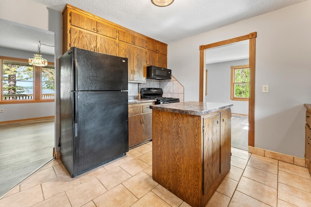 51470 Rush Lake Trl, Nessel Twp, MN 55069 - kitchen with black appliances, tasteful backsplash, a textured ceiling, baseboards, and a center island