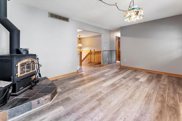 51470 Rush Lake Trl, Nessel Twp, MN 55069 - living room with a wood stove, wood finished floors, and baseboards