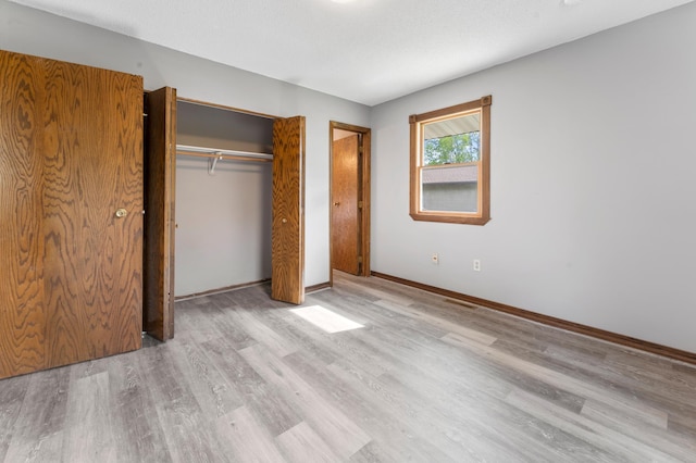 51470 Rush Lake Trl, Nessel Twp, MN 55069 - unfurnished bedroom featuring wood finished floors, a closet, and baseboards