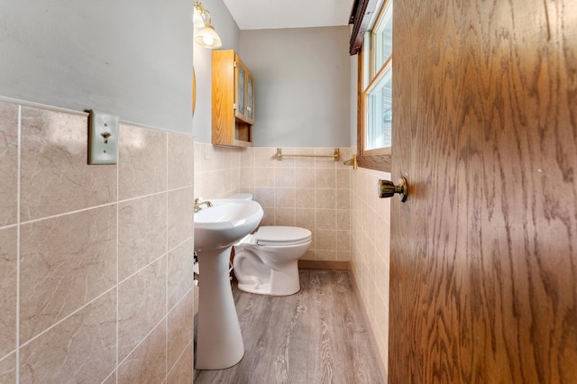 51470 Rush Lake Trl, Nessel Twp, MN 55069 - half bathroom featuring tile walls, wood finished floors, wainscoting, and toilet