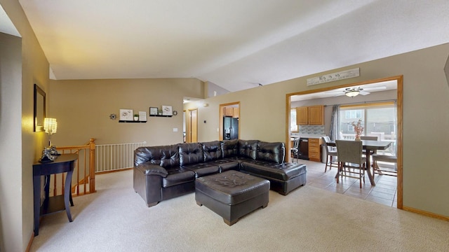 3224 48th St NW, Rochester, MN 55901 - living room with vaulted ceiling, light colored carpet, a ceiling fan, and light tile patterned flooring