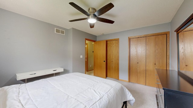 3224 48th St NW, Rochester, MN 55901 - bedroom featuring light carpet, two closets, and ceiling fan