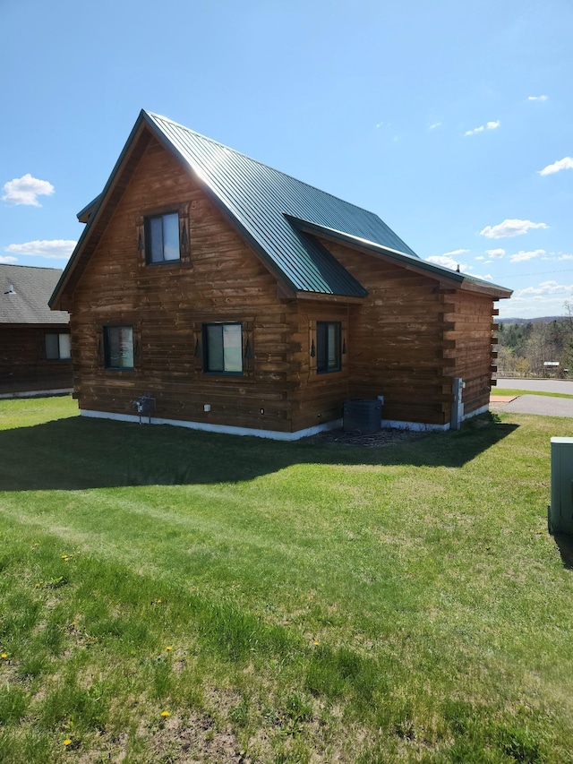 303 Hilltop Ct, Warrens, WI 54666 - view of side of property featuring log siding, a lawn, and a metal roof