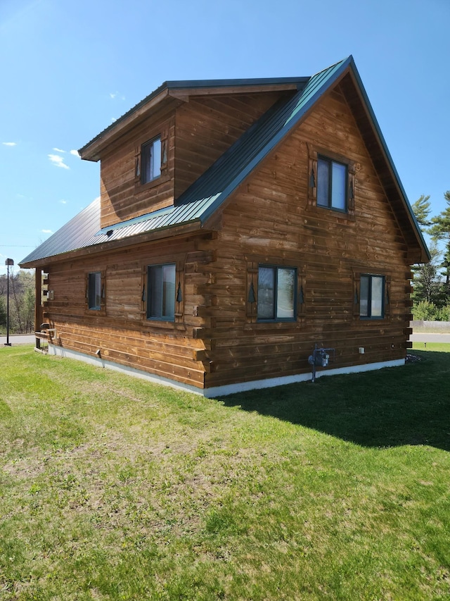 303 Hilltop Ct, Warrens, WI 54666 - view of property exterior featuring a yard, a metal roof, and log exterior