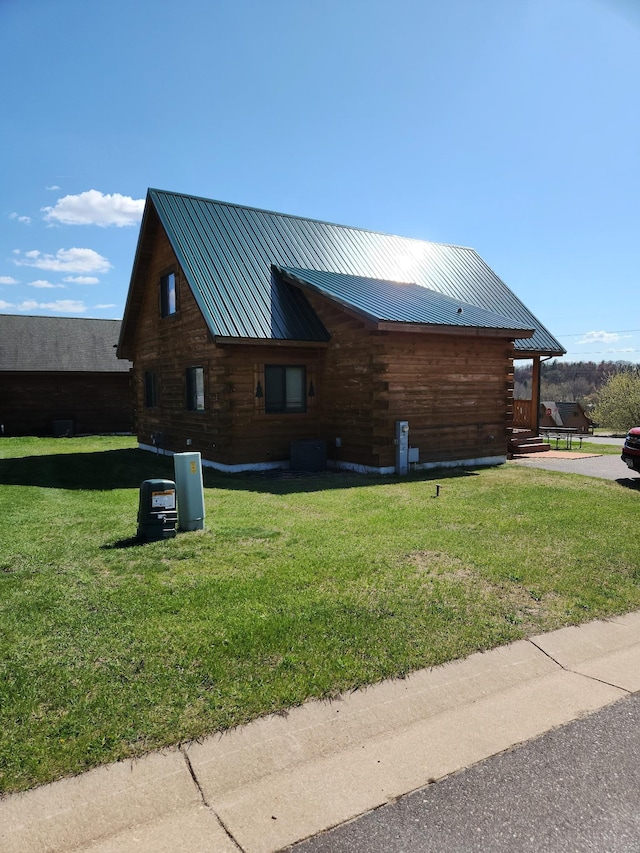 303 Hilltop Ct, Warrens, WI 54666 - view of side of property with log exterior and a lawn