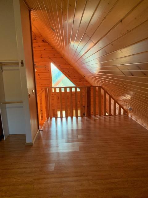 303 Hilltop Ct, Warrens, WI 54666 - bonus room with lofted ceiling, wood ceiling, wood walls, and wood finished floors