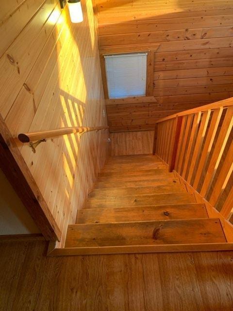 303 Hilltop Ct, Warrens, WI 54666 - staircase featuring hardwood / wood-style flooring and wood walls