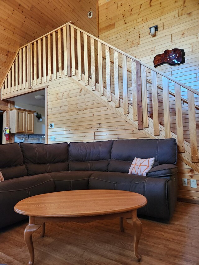 303 Hilltop Ct, Warrens, WI 54666 - living area featuring wood walls, wood finished floors, and a high ceiling