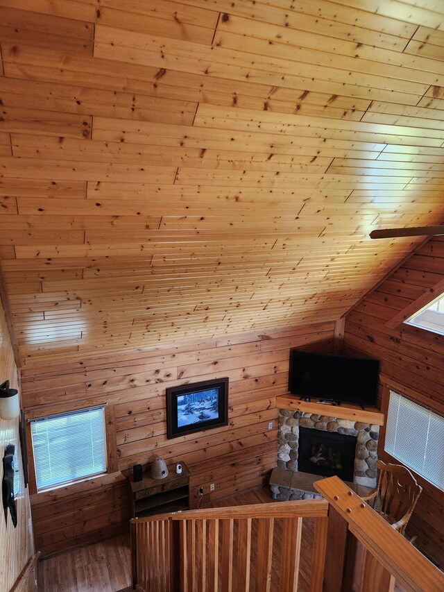 303 Hilltop Ct, Warrens, WI 54666 - living area with wooden walls, wood finished floors, vaulted ceiling, and plenty of natural light