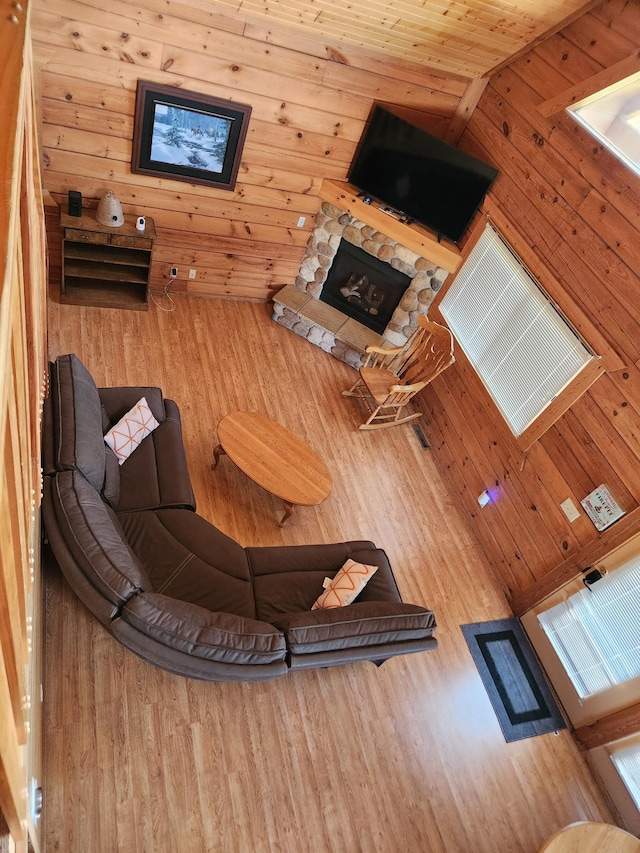 303 Hilltop Ct, Warrens, WI 54666 - living area featuring a fireplace, wooden walls, and wood finished floors