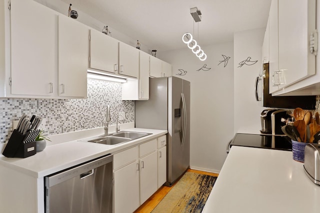121 Washington Ave S Unit 1816, Minneapolis, MN 55401 - kitchen with stainless steel appliances, a sink, tasteful backsplash, light countertops, and white cabinets