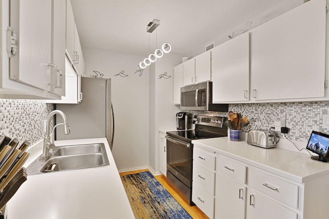 121 Washington Ave S Unit 1816, Minneapolis, MN 55401 - kitchen with stainless steel appliances, a sink, decorative backsplash, and white cabinetry