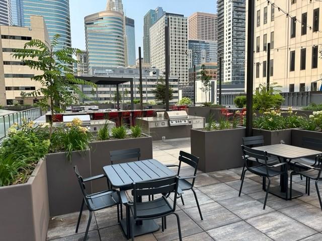 121 Washington Ave S Unit 1816, Minneapolis, MN 55401 - view of patio / terrace featuring a view of skyline and outdoor dining area