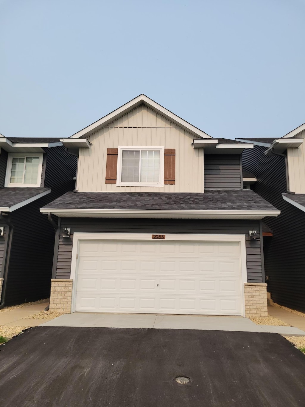 2233 Liberty Glen Loop, Saint Cloud, MN 56304 - view of front of home with brick siding, driveway, and an attached garage