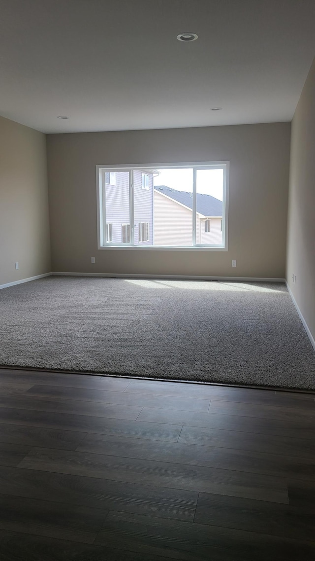 1027 45th Ave NE, Saint Cloud, MN 56304 - empty room featuring recessed lighting, baseboards, and wood finished floors