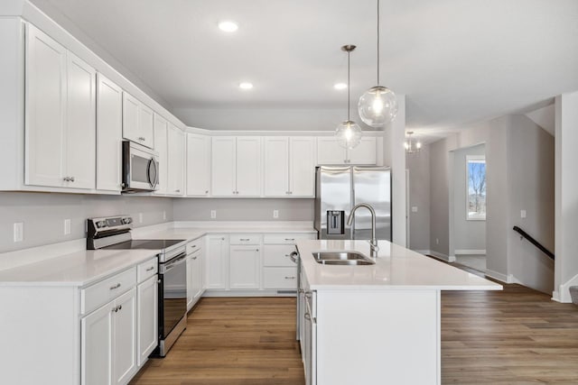 7442 171st Ln NW, Ramsey, MN 55303 - kitchen with stainless steel appliances, a sink, recessed lighting, a kitchen island with sink, and white cabinets