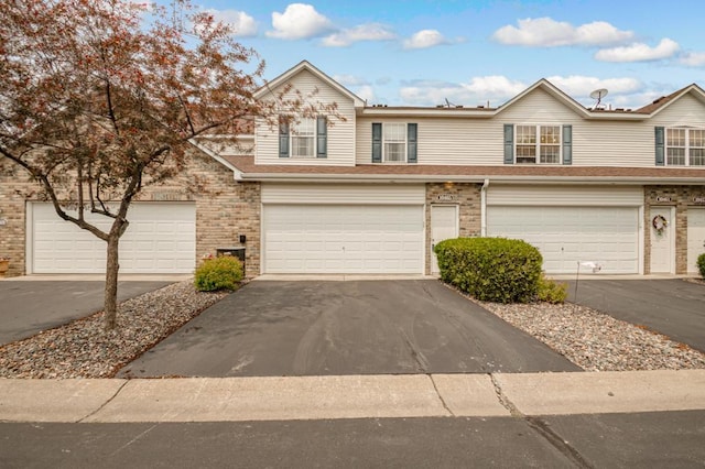10465 172nd Ln NW, Elk River, MN 55330 - view of front of home with a garage, driveway, and brick siding