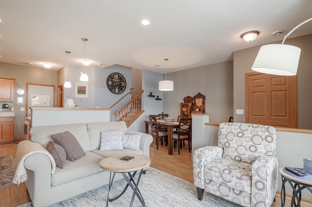 10465 172nd Ln NW, Elk River, MN 55330 - living room featuring stairs, light wood-style floors, and a textured ceiling