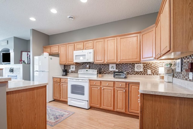 10465 172nd Ln NW, Elk River, MN 55330 - kitchen with white appliances, a textured ceiling, tasteful backsplash, light countertops, and light wood-type flooring
