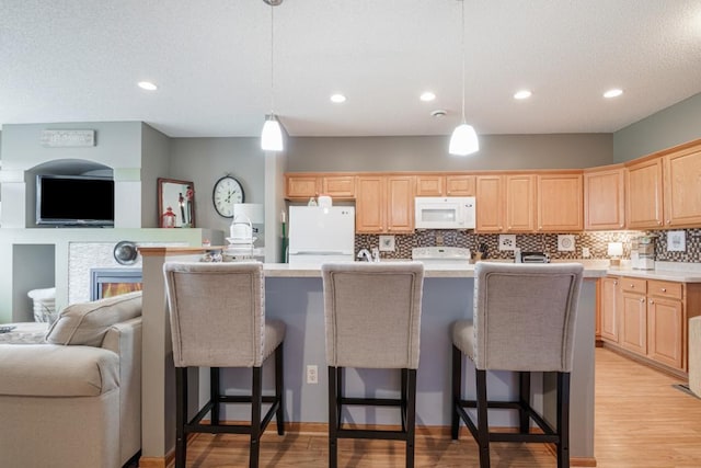 10465 172nd Ln NW, Elk River, MN 55330 - kitchen featuring white appliances, open floor plan, light brown cabinets, recessed lighting, and a textured ceiling