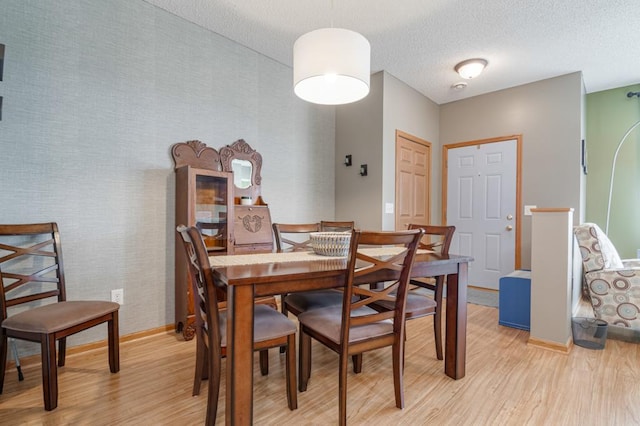 10465 172nd Ln NW, Elk River, MN 55330 - dining area with light wood finished floors, baseboards, and a textured ceiling