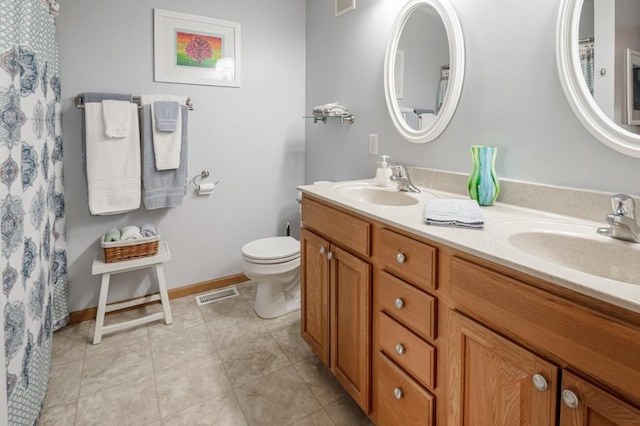 10465 172nd Ln NW, Elk River, MN 55330 - full bathroom featuring double vanity, toilet, baseboards, and tile patterned flooring