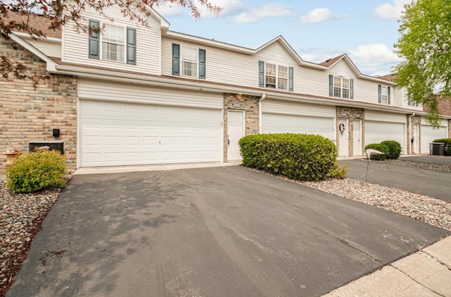 10465 172nd Ln NW, Elk River, MN 55330 - traditional home with a garage, driveway, and brick siding