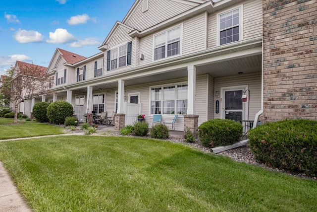 10465 172nd Ln NW, Elk River, MN 55330 - townhome / multi-family property featuring a porch and a front yard
