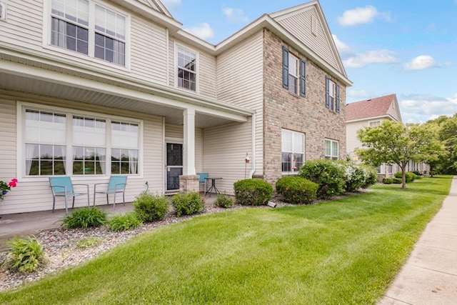 10465 172nd Ln NW, Elk River, MN 55330 - traditional-style house featuring a front yard, stone siding, and covered porch