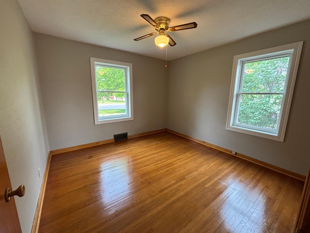 912 Arnold Ave N, Thief River Falls, MN 56701 - unfurnished room with wood finished floors, a ceiling fan, and baseboards