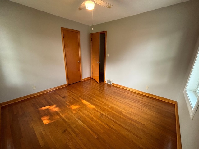 912 Arnold Ave N, Thief River Falls, MN 56701 - empty room featuring ceiling fan, dark wood-style floors, and baseboards
