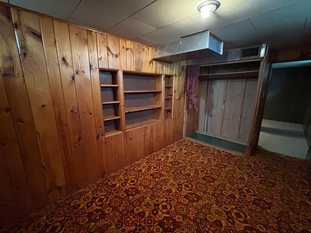 912 Arnold Ave N, Thief River Falls, MN 56701 - unfurnished bedroom featuring wooden walls and carpet floors
