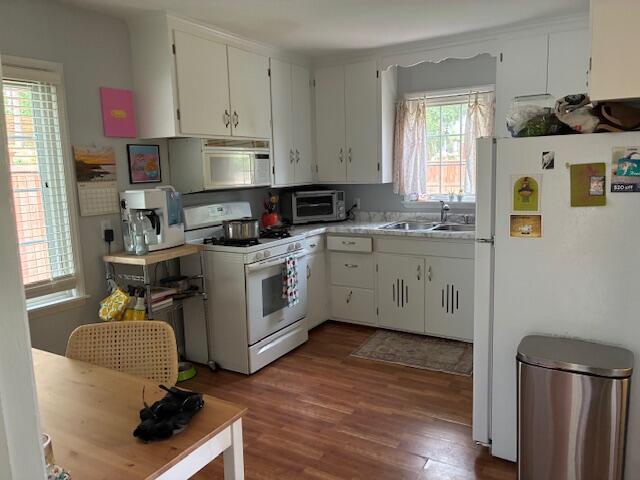 4901 Bryant Ave S, Minneapolis, MN 55419 - kitchen with white appliances, a sink, dark wood-style flooring, light countertops, and white cabinetry